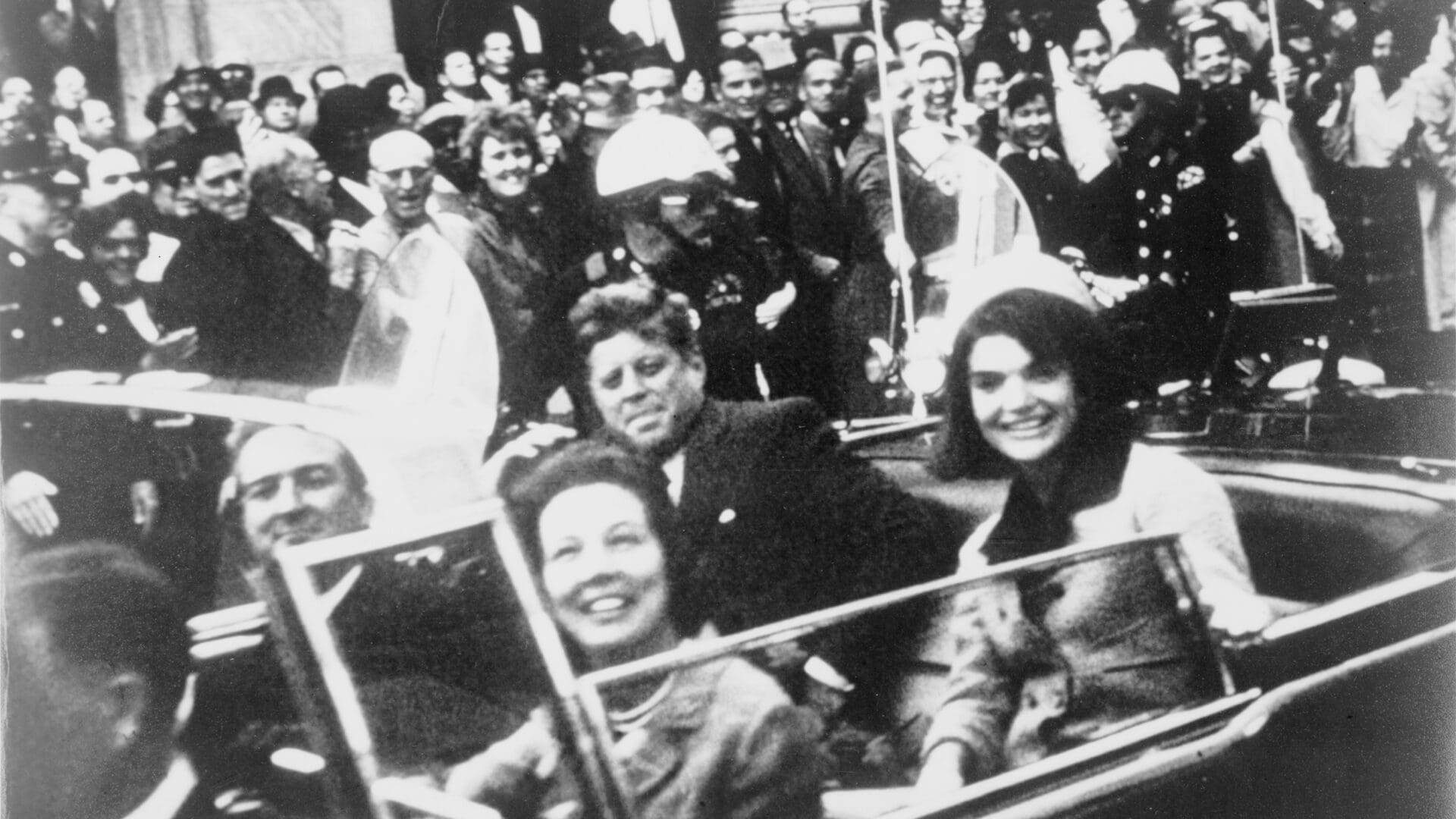 President John F. Kennedy and his wife Jacqueline with Texas Governor John Connally and his wife, Nellie Connally in the presidential limousine just before the assassination on 22 November 1963