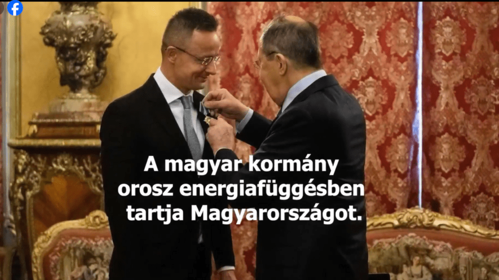 A screenshot of the Embassy video, with Russian Foreign Minister Lavrov (L) decorating Péter Szijjártó. The caption reads: ‘The Hungarian Government is keeping Hungary dependent on Russian energy.’