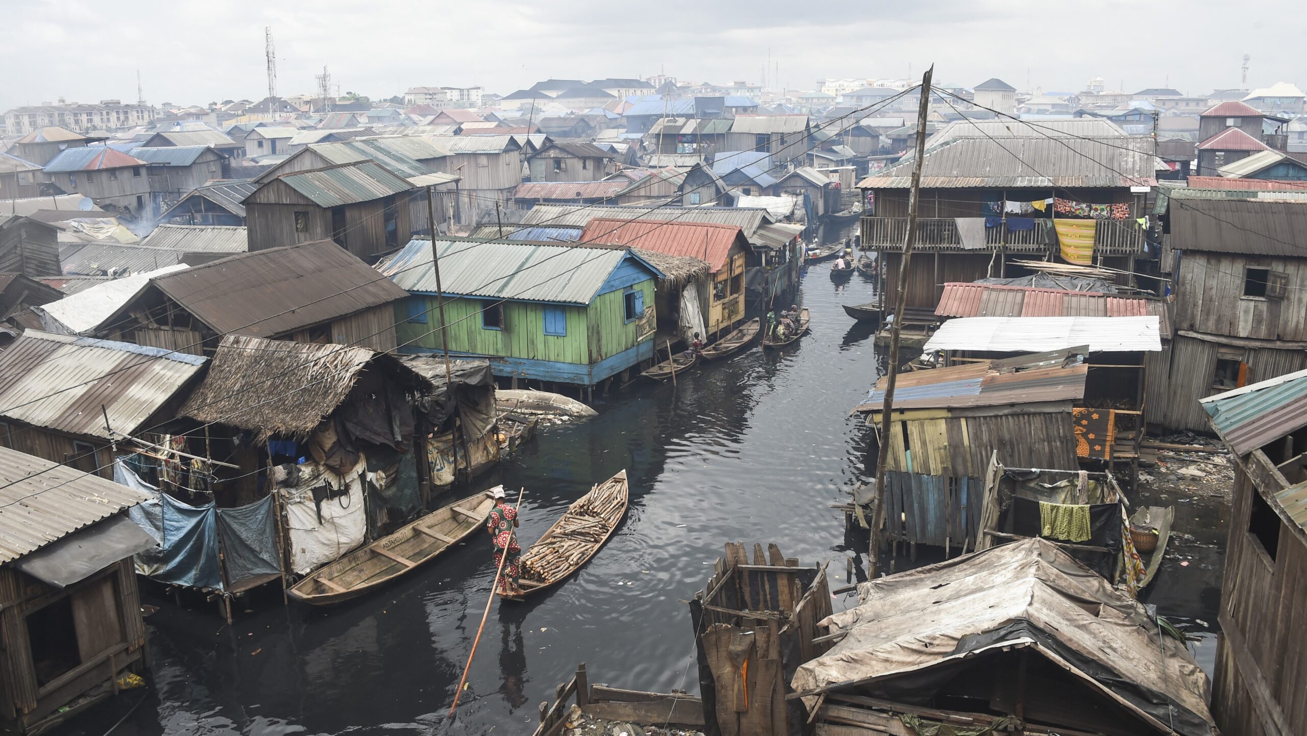 People in pirogues navigate their way in the slum community of Makoko in Lagos, Nigeria's commercial capital, on 19 October 2022