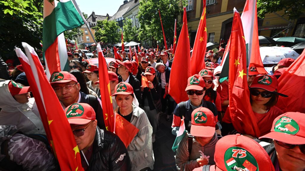 Supporters of China hold Chinese and Hungarian flags in the Buda Castle close to the route of Chinese President Xi Jinping’s motorcade prior to his meeting with Viktor Orbán on 9 May 2024 in Budapest.