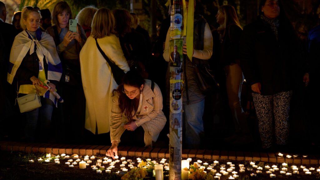 Attendees light candles in memory of the victims of the 7 October terrorist attacks in Budapest on 7 October 2024 outside the Dohány Street synagogue.