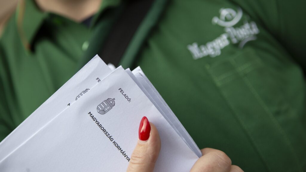 A postwoman delivers National Consultation questionnaires in a Budapest block of flats on 28 October 2024.