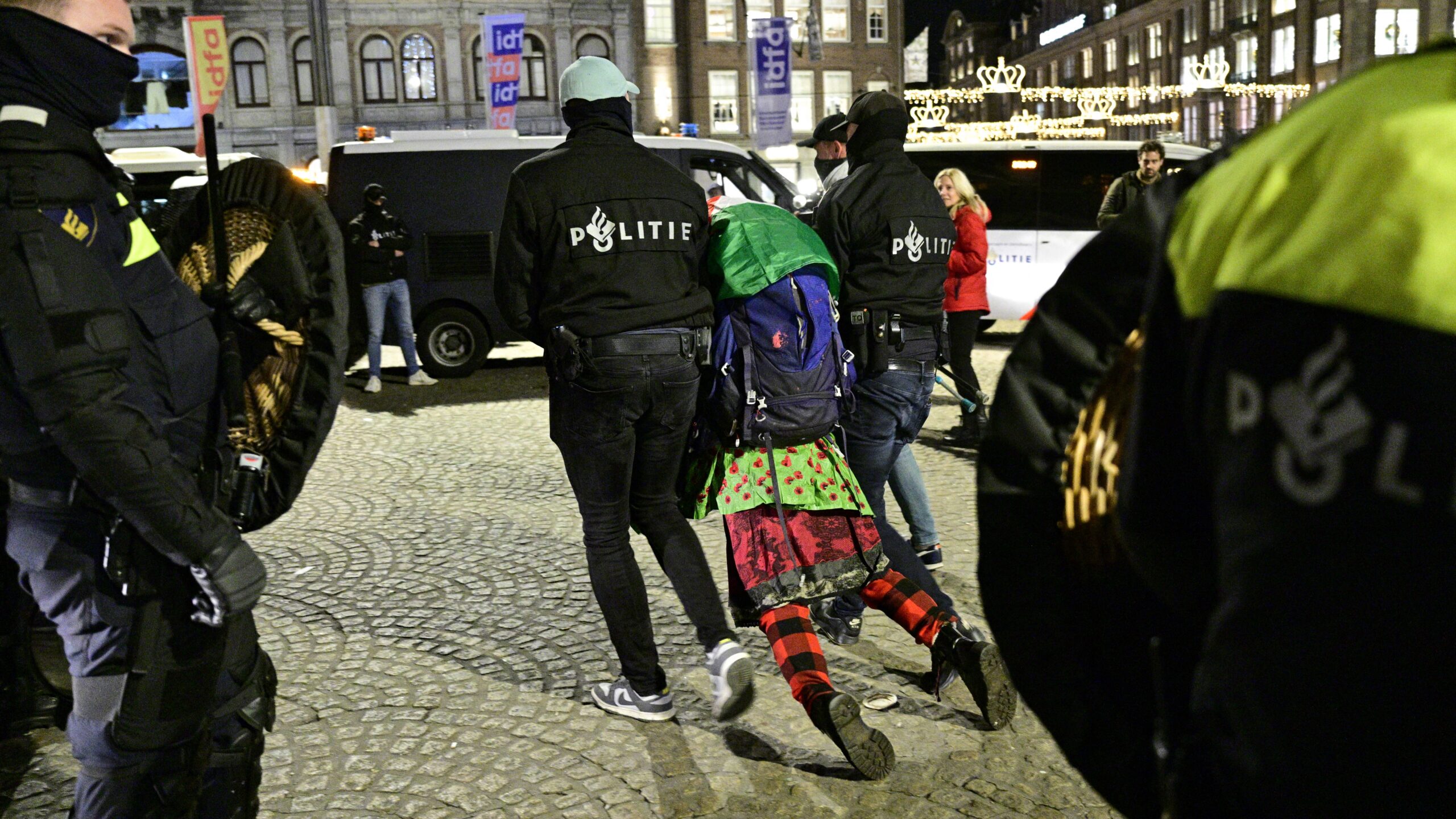 Police officers detain a protestor during an unauthorised pro-Palestinian demonstration on Dam Square in Amsterdam on November 13, 2024.