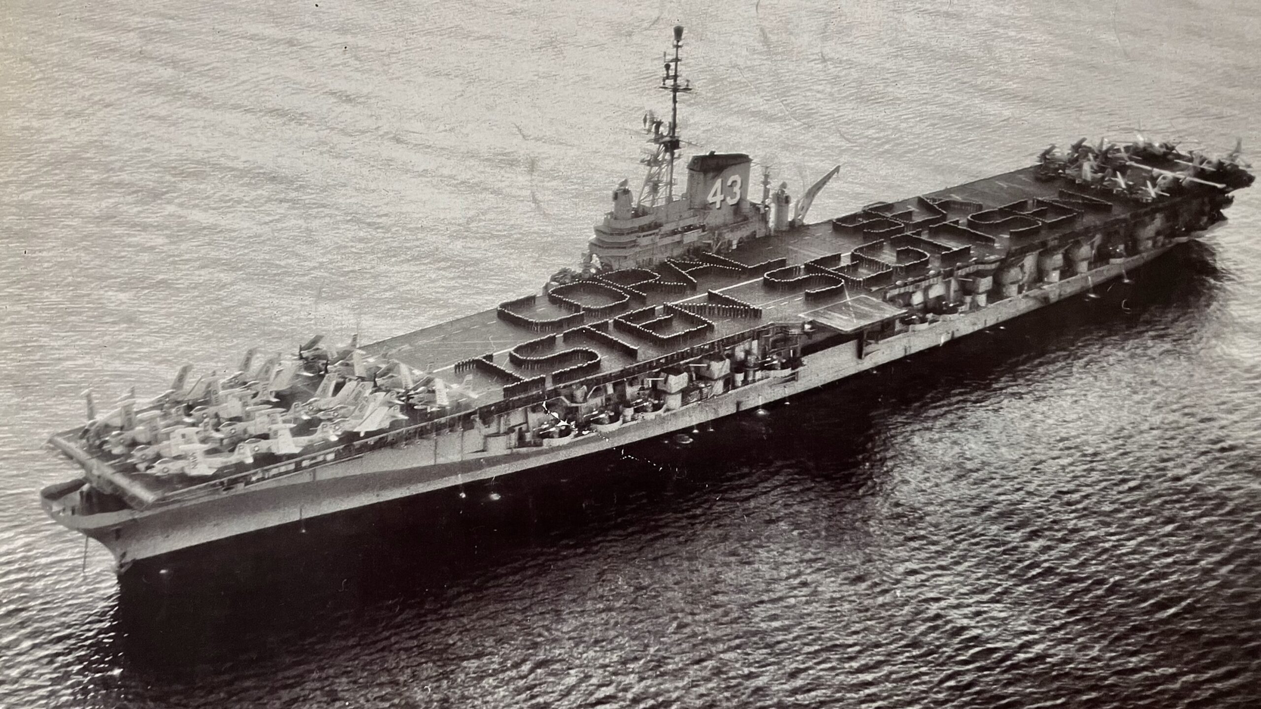 The USS Coral Sea at the end of 1956 with the message May God help you