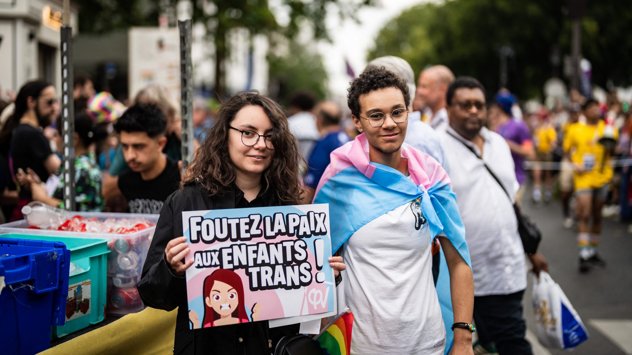 Young demonstrators with the trans flag and a placard with the message leave trans children alone , with the logo of the party La France Insoumise, LFI, extreme left party,