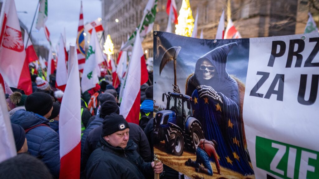 Demonstrators hold up Polish flags outside the European Union Commission representation in Warsaw, Poland, on 3 January 2025 during a protest against EU agricultural policies.